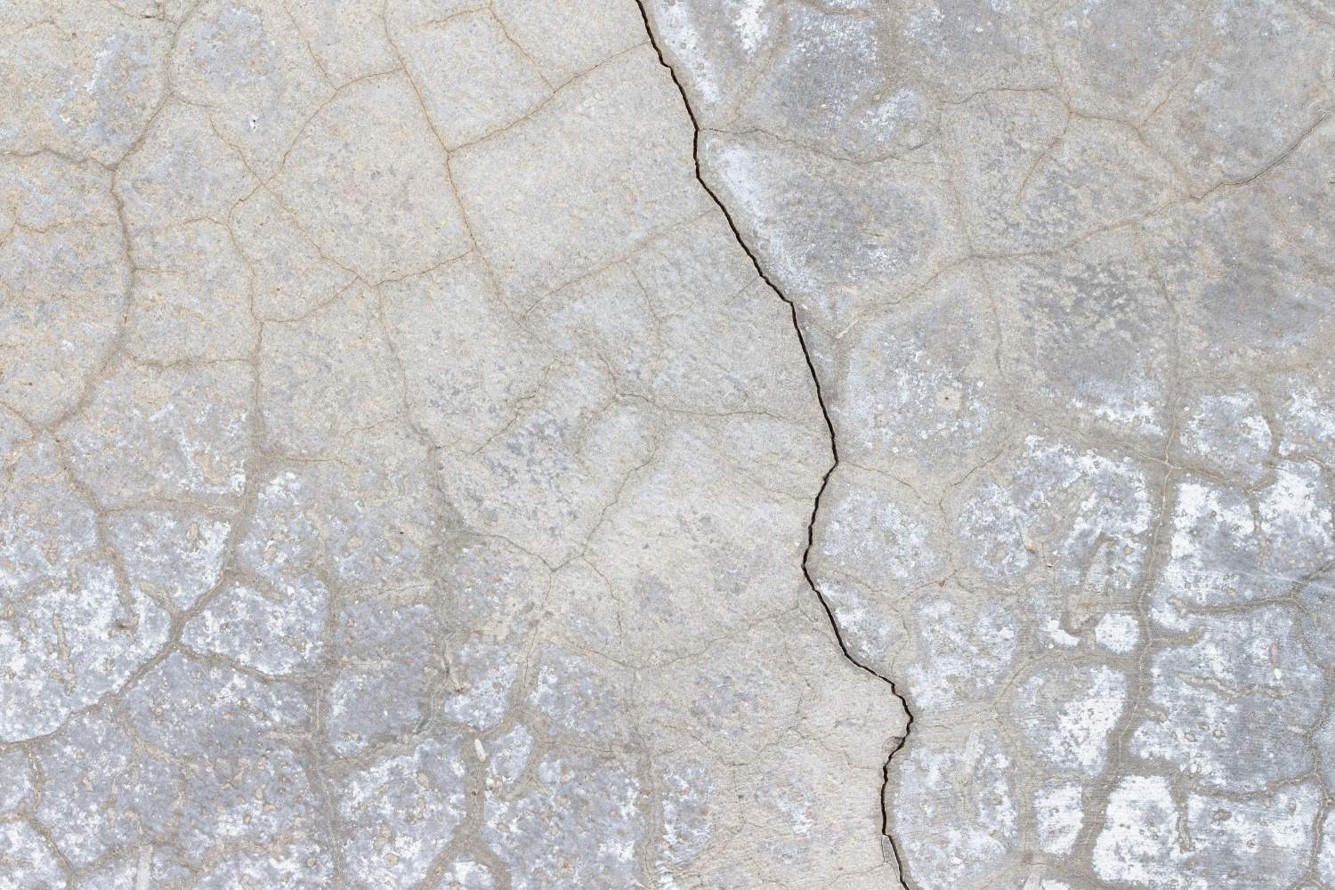 Cracked concrete surface with visible texture and weathering.